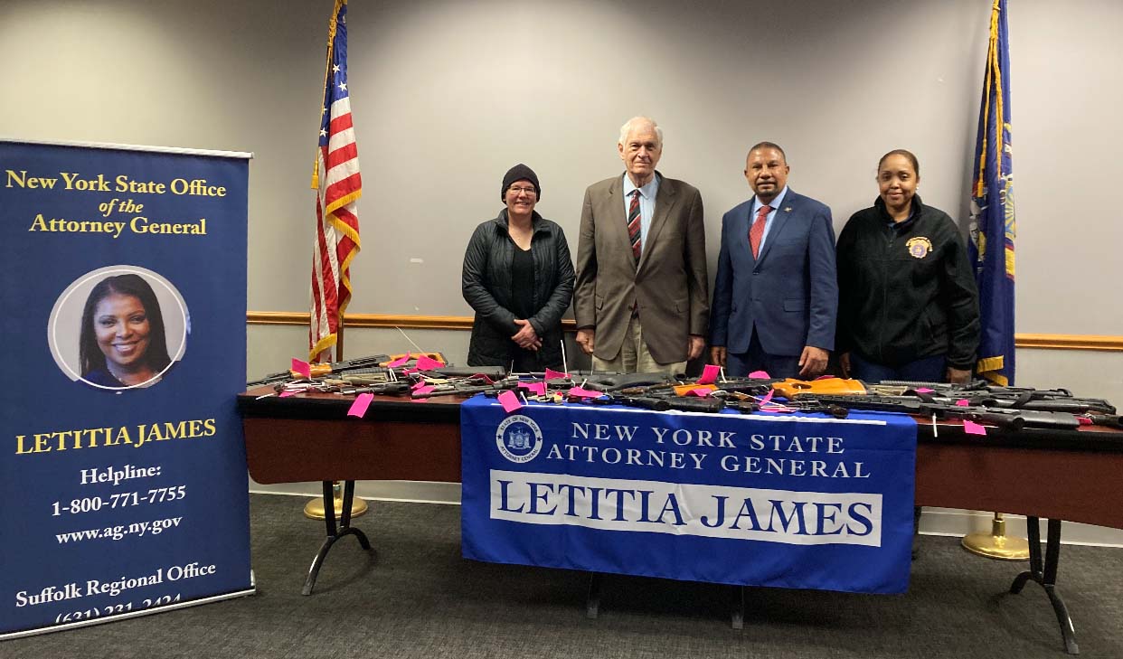 several guns on a blue tablecloth with the text New York State Attorney General Letitia James