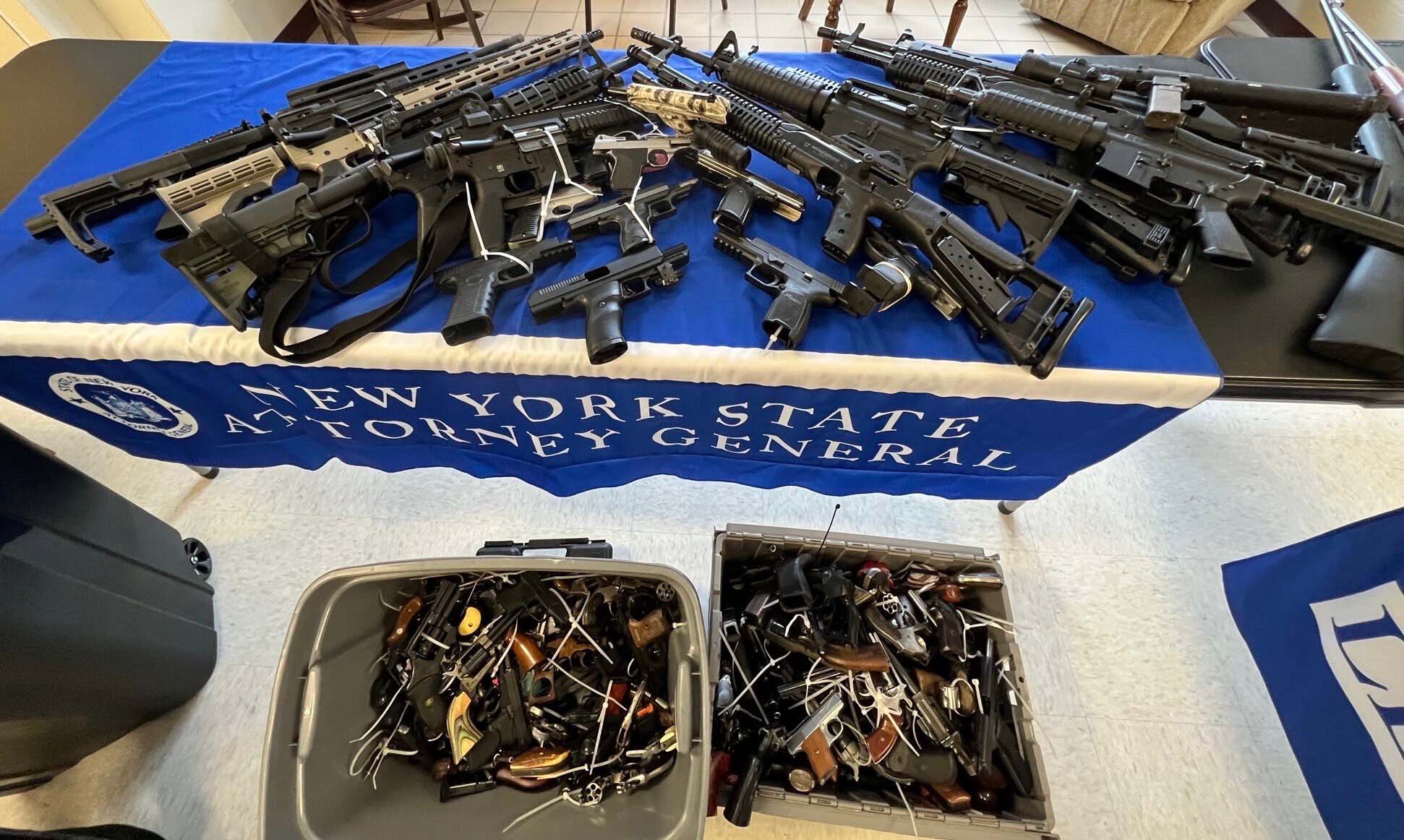 hundreds of guns in buckets and on a table