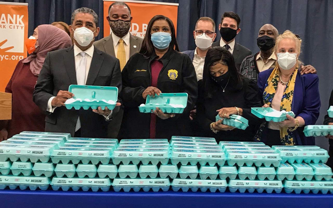 Group of people around a table filled with egg cartons