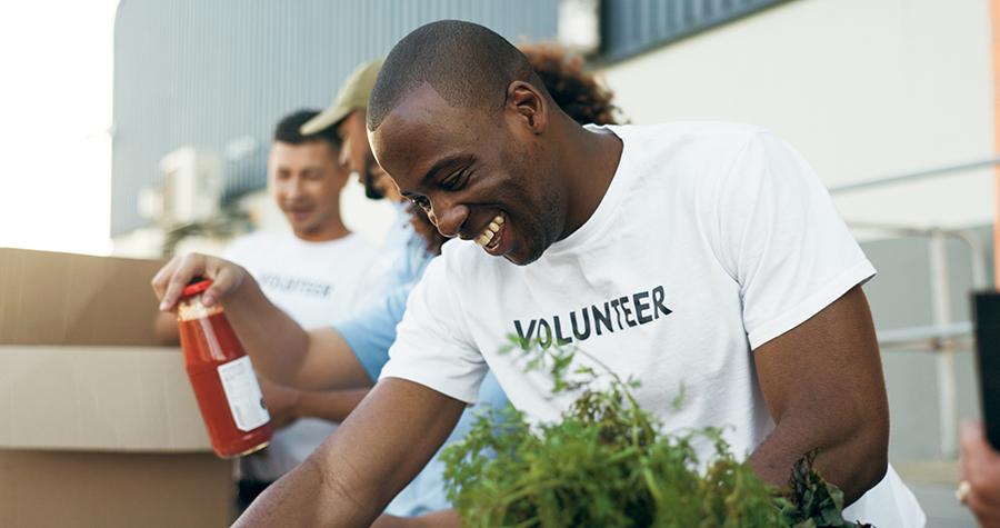 Volunteer Black man helping sort items that were donated