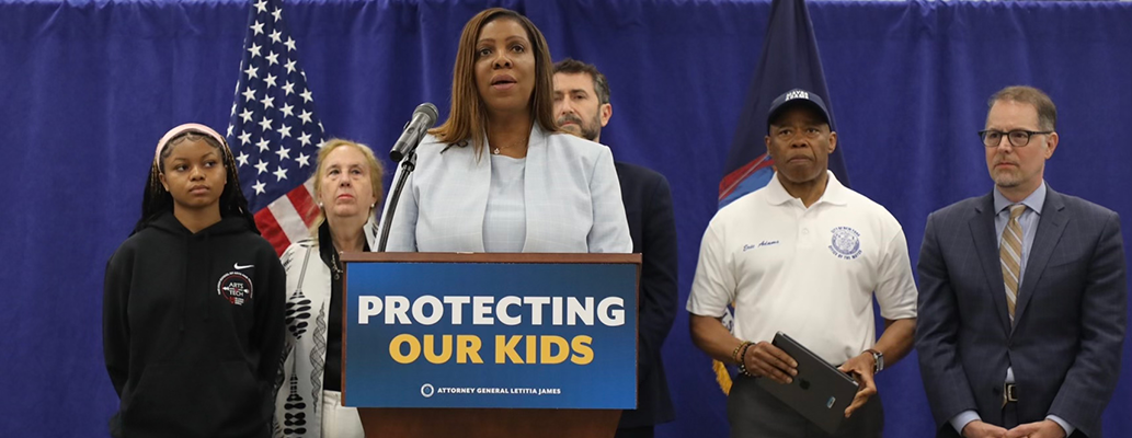 AG James at a podium with a sign that reads Protecting Our Kids