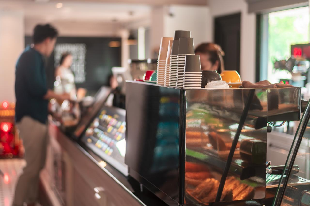 a cafe counter with customer ordering