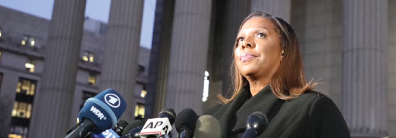 AG James at poduim with microphones