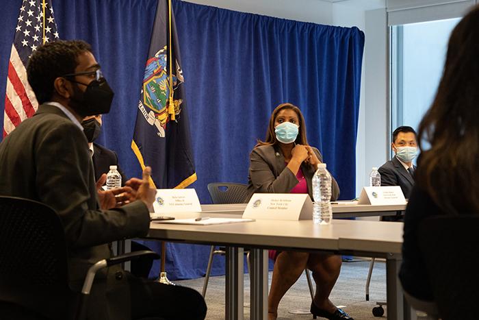 AAPI group at table with AG James