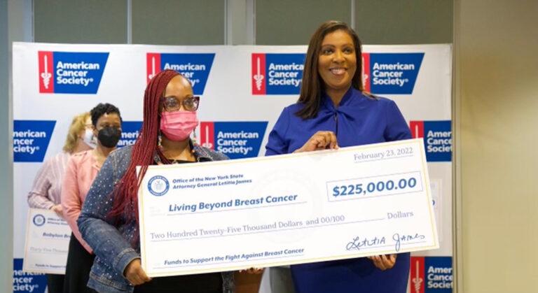 AG James holding check for cancer society