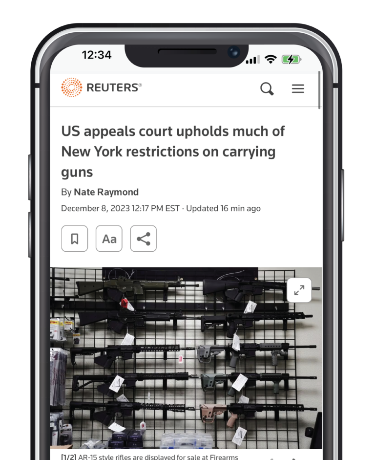Phone displaying Reuters news article on US appeals of NY gun restrictions