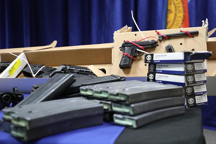 Gun rounds on table with gun on display