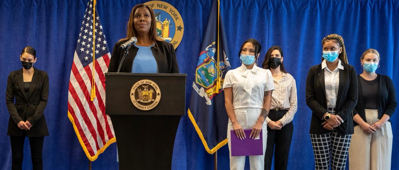 AG James behind podium with others speaking about fighting for Bar employees 