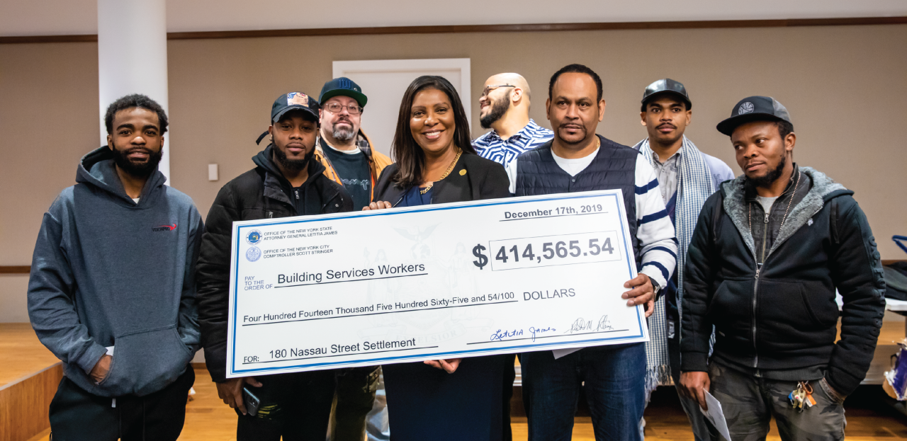 Ag James and workers holding check