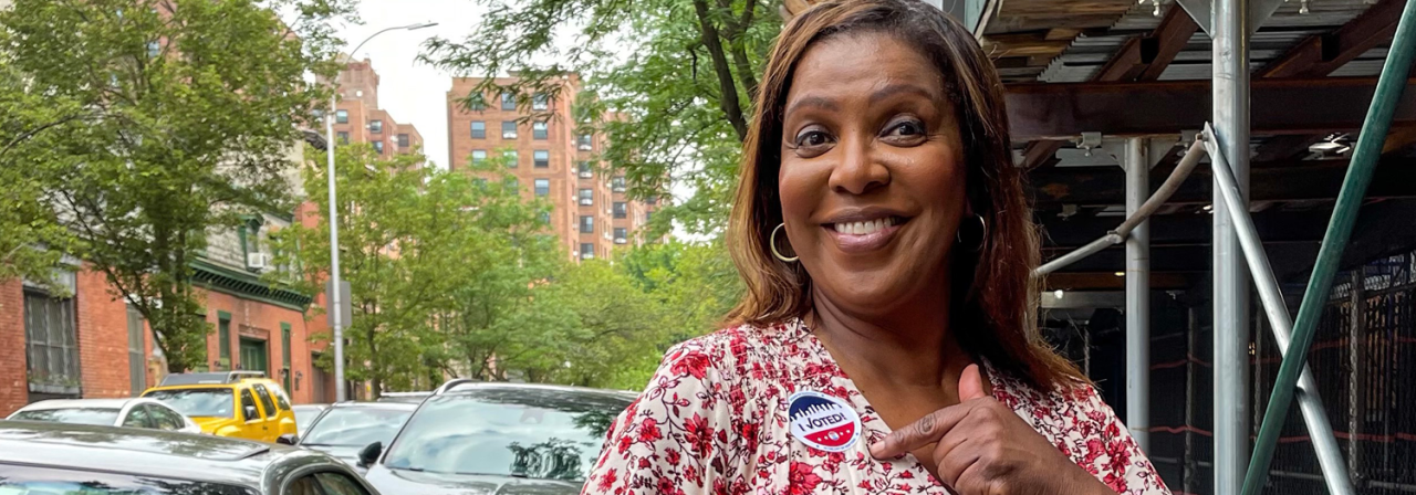Ag James pointing to her "I voted" sticker