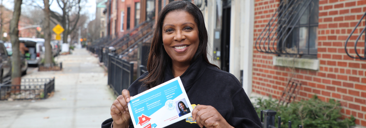 AG James holding safe housing card