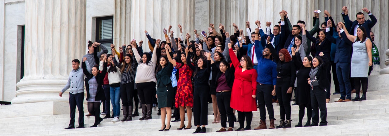people holding hands in supports of immigrants' rights