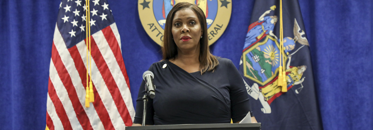 AG James standing behind podium