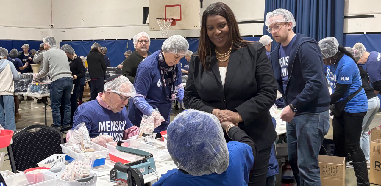 AG James shaking hands with a community volunteer
