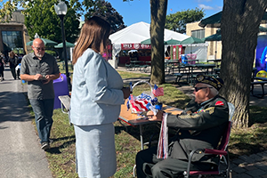 AG James speaking with a veteran