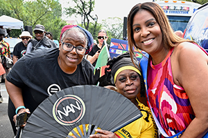 AG James with two other people marching in parade