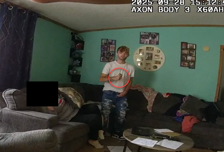 Still from Trooper Butcher’s BWC video showing Mr. Novakowski holding the scissors when the Trooper arrived at the house.