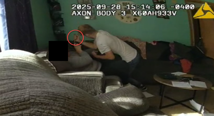 Still from Trooper Butcher’s BWC video showing Mr. Novakowski advancing toward his mother, making a downward stabbing motion with the scissors.