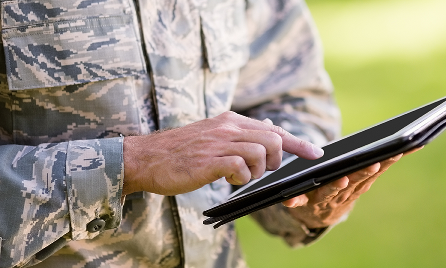 person in a military uniform on an iPad