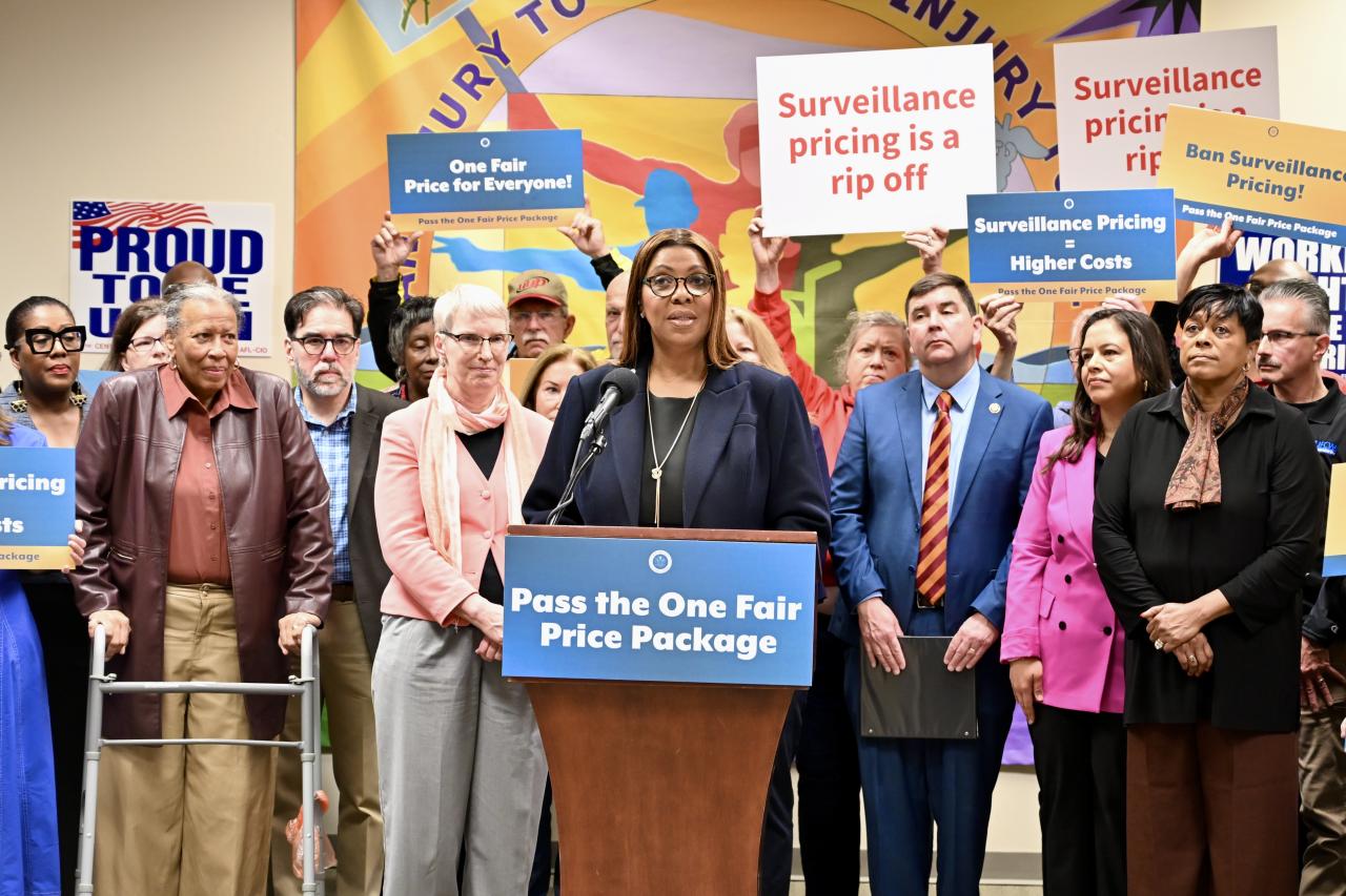 AG James at a podium with a group of people behind her