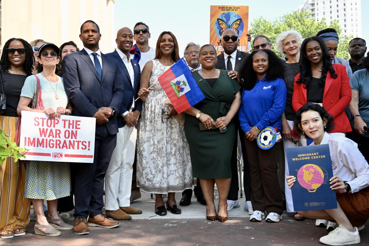 AG James holding a flag with a group of people
