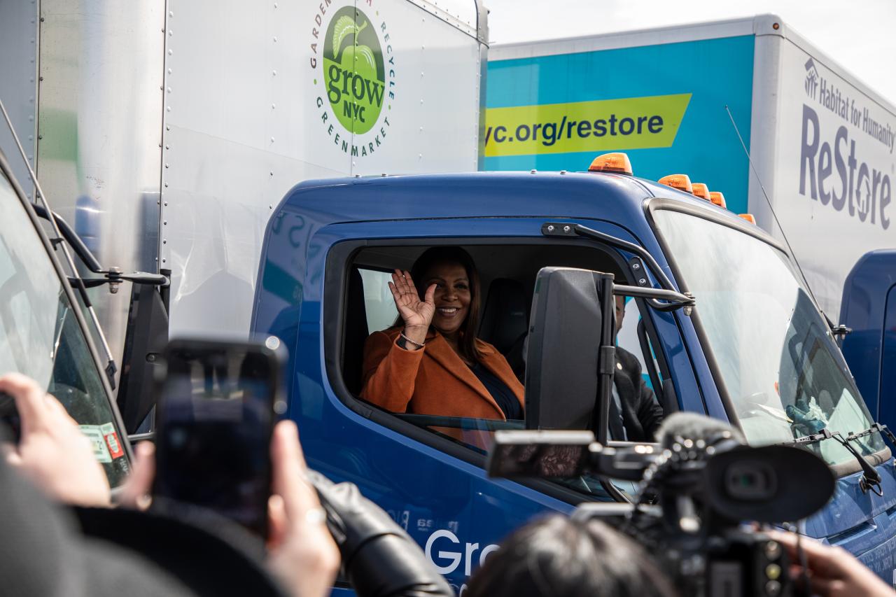 AG James in a truck waving out the window