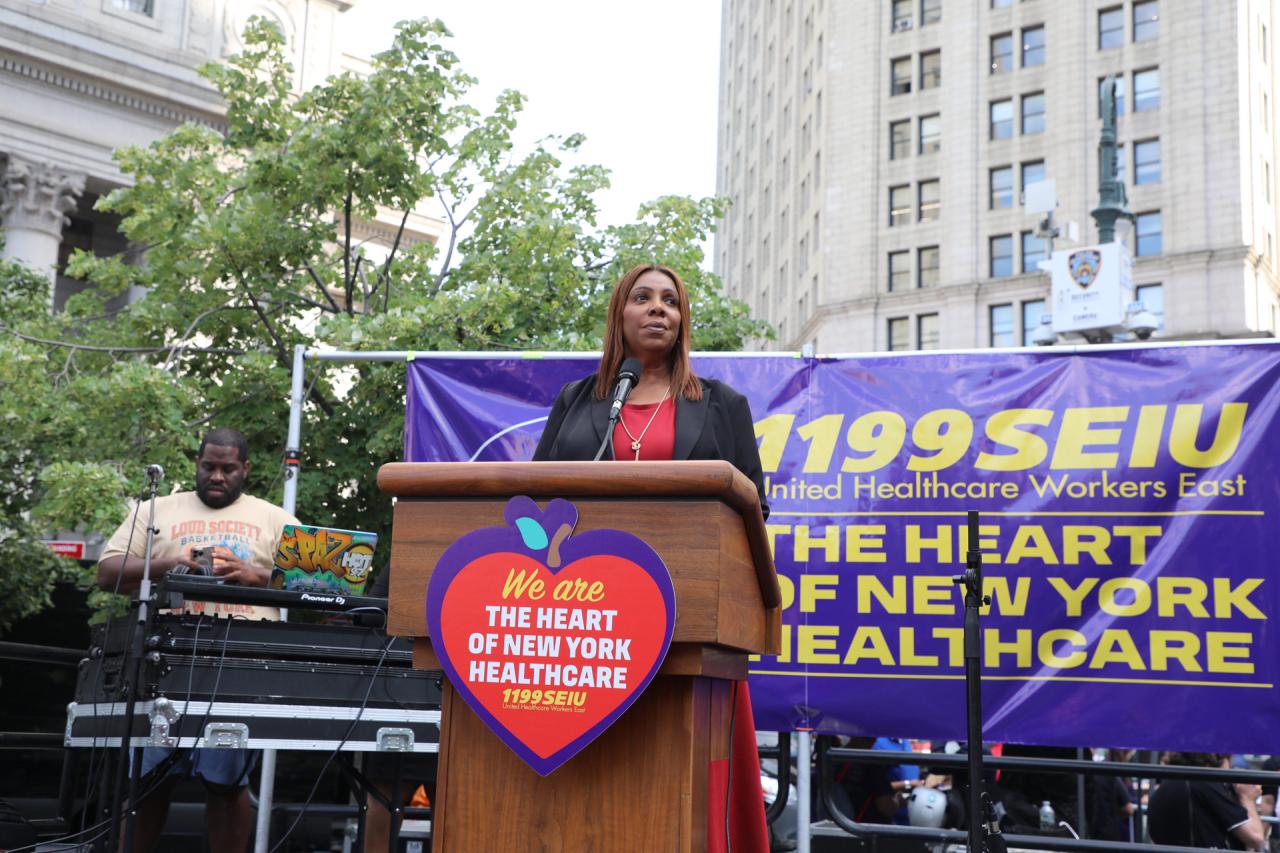 AG James at a podium for health care workers