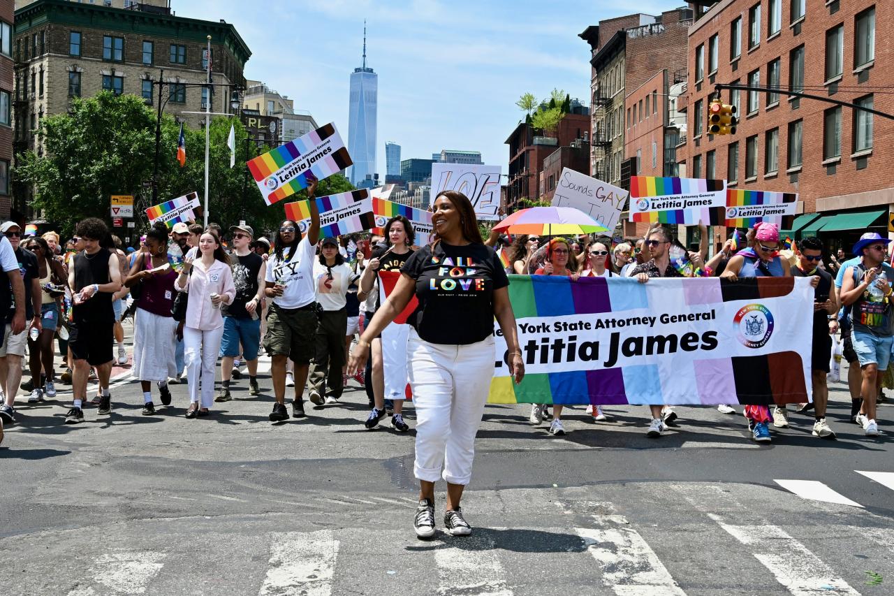 AG James marching in the Pride parade with lots of people behind her